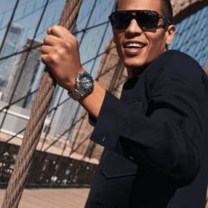 Michael Kors Watches man with grey watch on a cable bridge