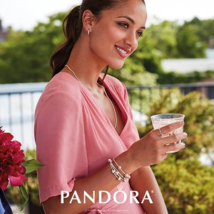 Pandora Essence Jewelry Collection metallic grey charm and jewel bracelet on a model wearing pink