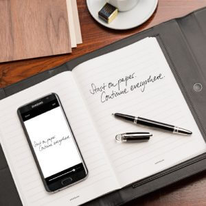 Montblanc augmented paper black file folder and black smartphone on a white table