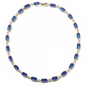 Long blue topaz and yellow gold necklace by A & Furst Jewelry at Kirk Freeport in Grand Cayman