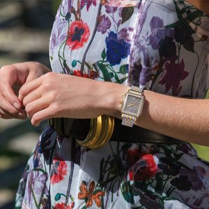 Michele Watches metallic grey watch on a woman wearing a floral dress