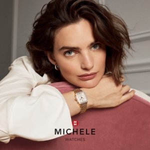 Michele Watches woman posing on sofa wearing a gold and silver watch