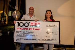 Kirk Freeport 100 Men Who Give a Damn donation cheque to the Breast Cancer Foundation of Cayman
