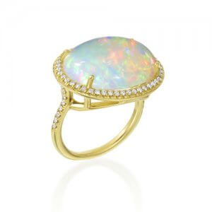 Lauren K opaque jewel on a gold ring surrounded by diamonds